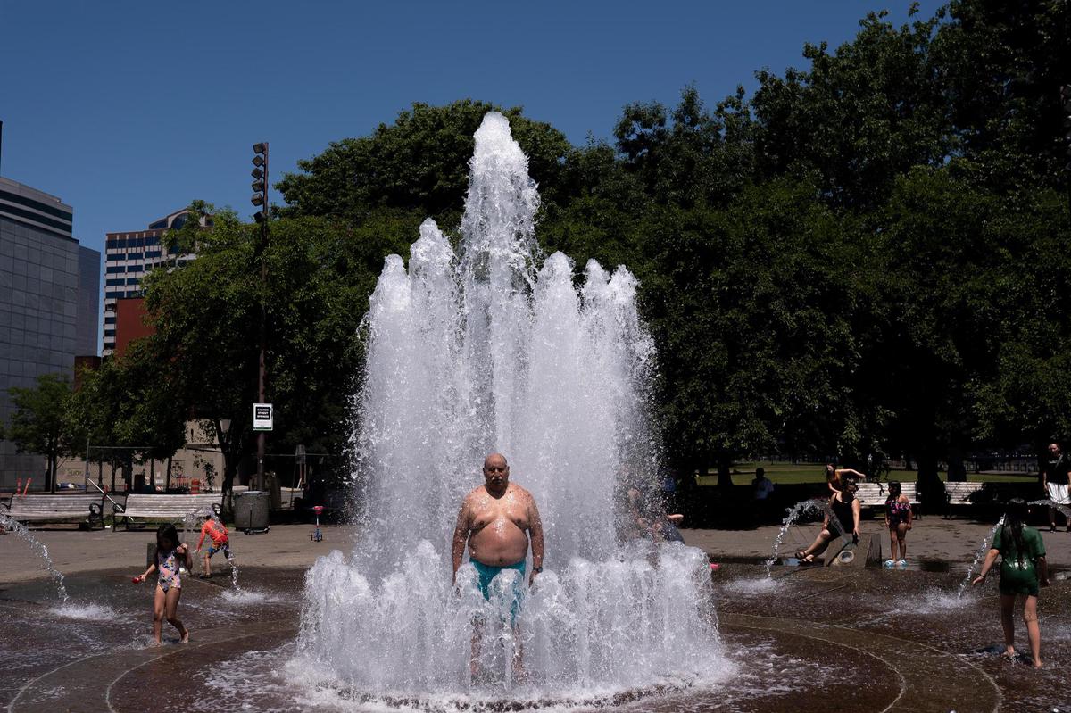 PORTLAND, Oregon - JUNE 27: Pablo Miranda cools off at Salmon Springs Fountain on June 27, 2021 in Portland, Oregon.  Record temperatures remained in the Northwest during this weekend's historic heat wave.  (Photo by Nathan Howard/Getty Images)