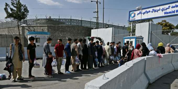 Afghans wishing to leave the country at Kabul airport