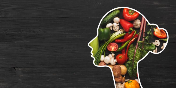A woman's head silhouette filled with healthy fruits and vegetables.