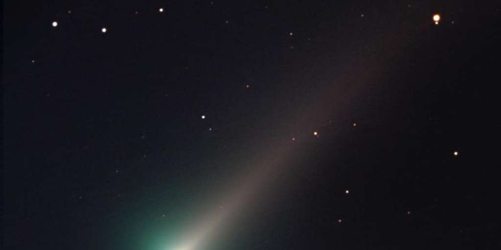 A comet flies across the Earth in the vastness of space