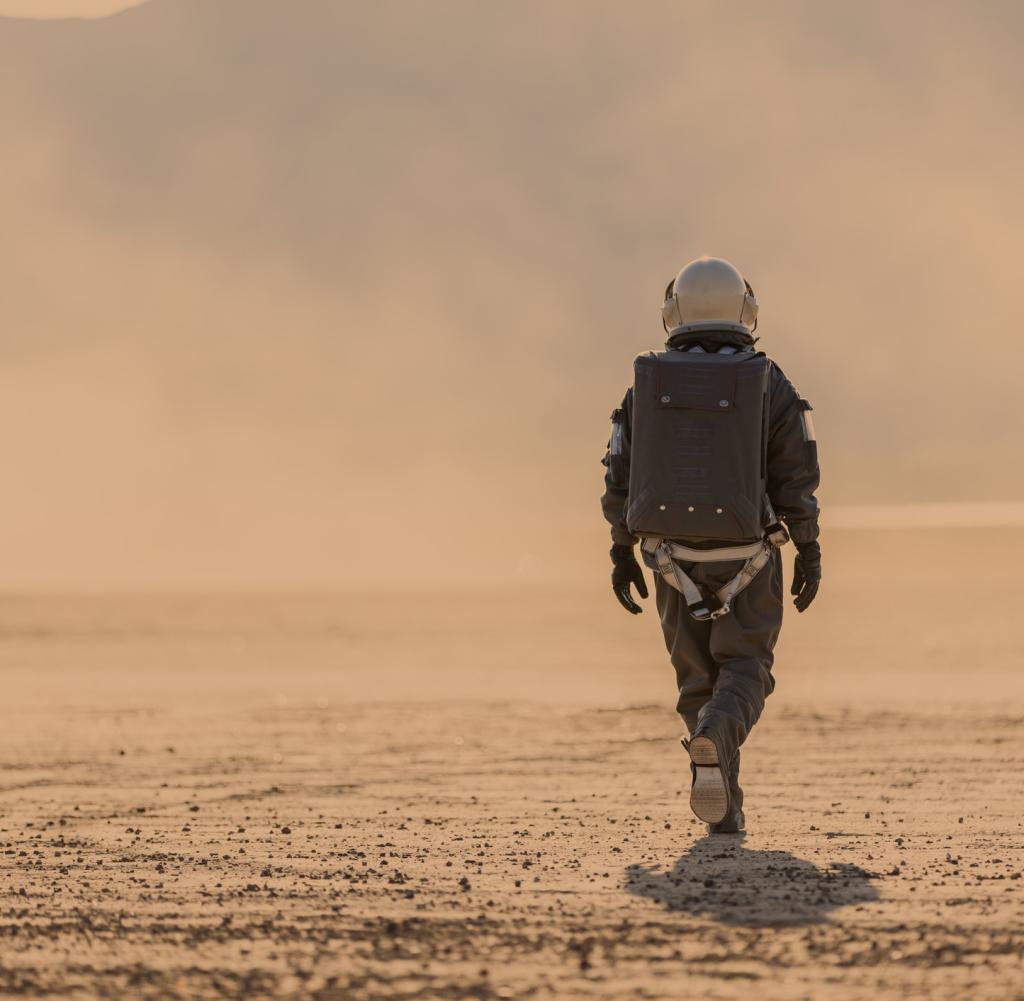 An astronaut walking on the surface of Mars