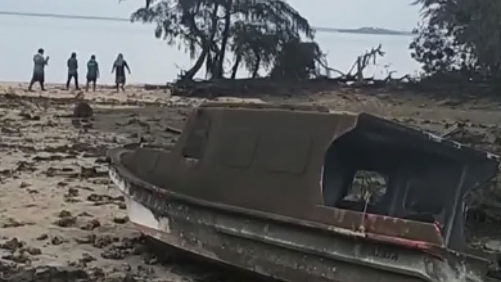 This image from a video provided by Broadcom Broadcasting shows a damaged boat on Atata Island in Tonga, Sunday, January 16, 2022, the day after a volcanic eruption tsunami near Tonga.  (Kilo Folau / Broadcom Broadcasting via AP)