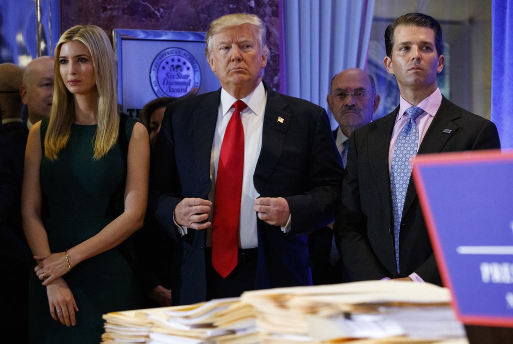 The Manhattan Attorney General's Office has conducted a criminal investigation into the business conduct of the Trump group.  Charges have been filed against the Trump Organization and its chief financial officer, Allen Weisselberg (pictured in the background), for tax fraud.  Pictured: Ivanka, Donald and Donald Jr..  trump card.