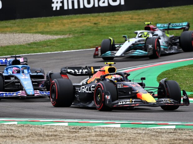 Lewis Hamilton in Mercedes W13 behind Sergio Perez in Red Bull and Fernando Alonso in the Alps
