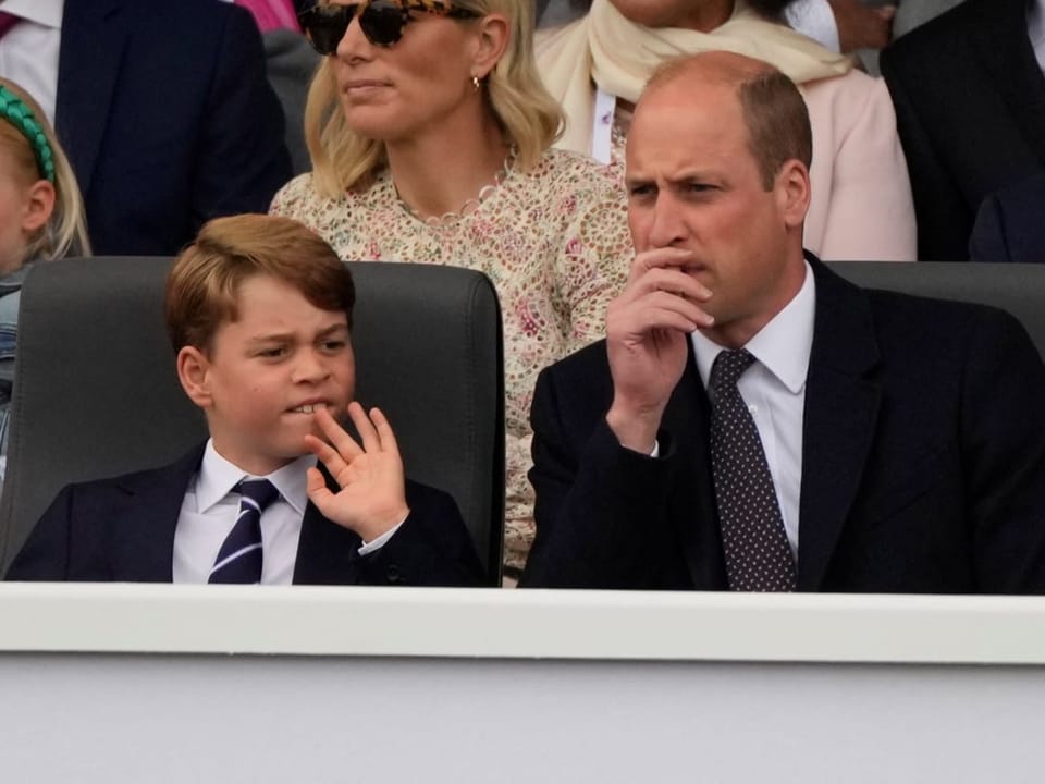 Prince William with his son George at the color parade in honor of the Queen.