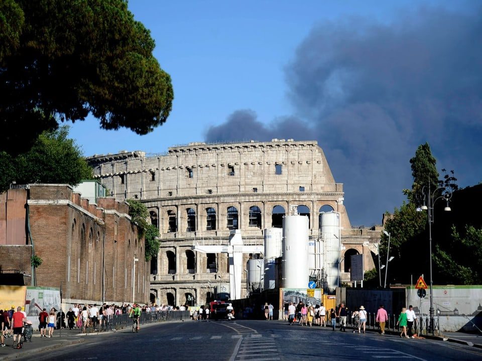Shots of the Colosseum in Rome, behind a thick cloud of smoke