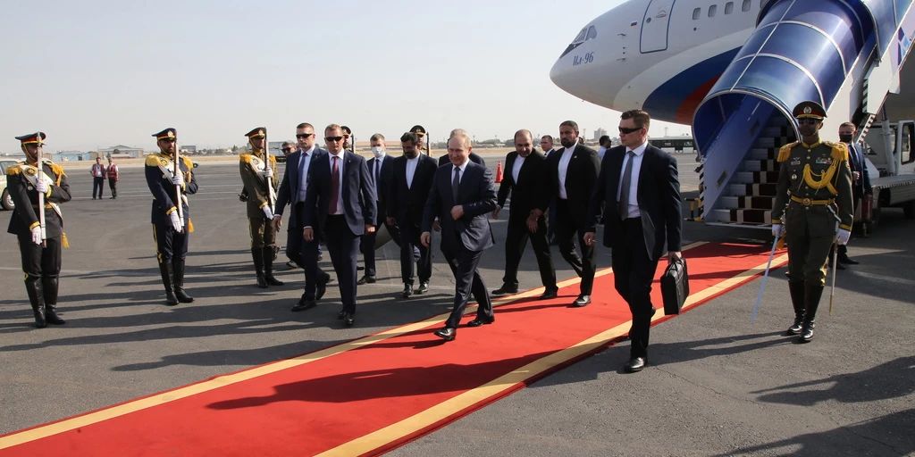 Vladimir Putin shows off his flabby arm in Iran