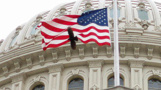 The American flag flies over the U.S. Capitol building in Washington
