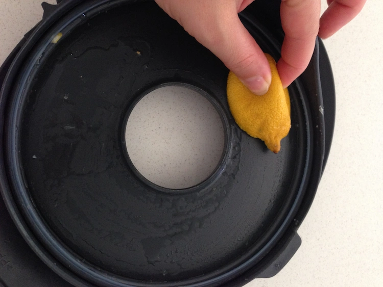 Take a lemon and clean the plastic cover of the Theromix Kitchen Appliance