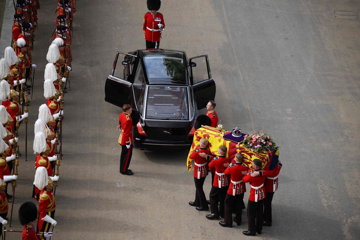 The Queen's casket is carried to State Hearse, a jaguar designed specifically for royal funerals. 