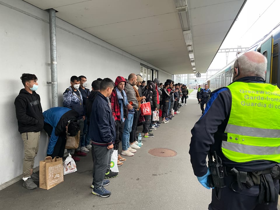 Migrants standing at Buchs train station